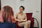 Fototapeta  - Female friendly psychologist talking with patients on therapy session