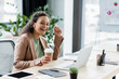 © LIGHTFIELD STUDIOS - african american businesswoman with coffee to go smiling during video call on laptop in office