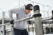 Young athletic man doing dips on a parallel bars during his winter workout