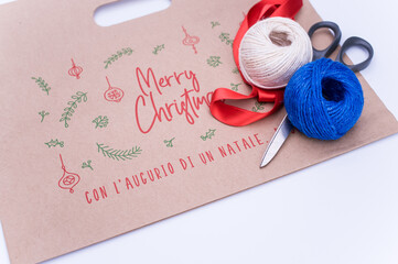 Sticker - decorated Kraft paper bag with stationery on a white background