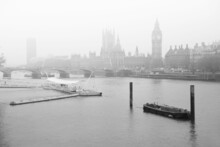 Black And White Image Of Fog Descending On The River Thames With Parliament