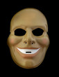 © Yuval Helfman - Sinister Smiler Mask Isolated Against Black Background