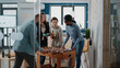 © DC Studio - Frustrated man losing foosball game having fun after work at office. Woman beating person while playing football at play table, enjoying bottles of beer and leisure with colleagues