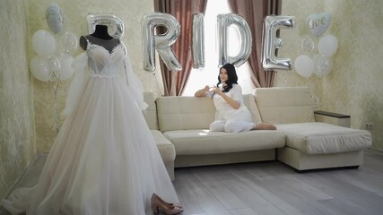 Wall Mural - morning of the bride. a beautiful young woman in white pajamas drinking tea.