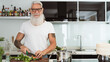 © Alessandro Biascioli - Happy senior man having fun cooking at home - Elderly person preparing health lunch in modern kitchen - Retired lifestyle time and food nutrition concept