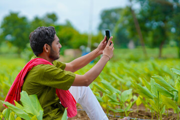 Poster - Indian farmer using smartphone at agriculture field