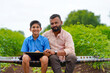 © Niks Ads - Cute indian farmer child studying with his father at home