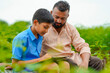 © Niks Ads - Cute indian farmer child studying with his father at home