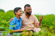 © Niks Ads - Cute indian farmer child studying with his father at home