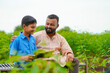 © Niks Ads - Cute indian farmer child studying with his father at home