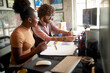 © luckybusiness - Young driven colleagues doing paperwork together