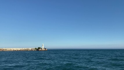 Canvas Print - Seascape with a view of the white lighthouse. Yalta, Crimea