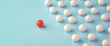 Leadership Concept: A group of white spheres with one sphere in red leading the group. Web banner format