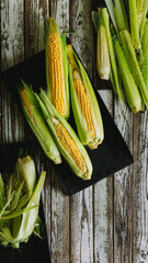 Poster - Top view of fresh corns on a wooden table