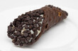Closeup of a Large Chocolate Covered Cannoli on a White Plate