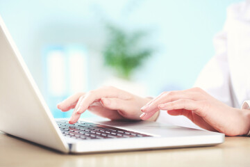 Poster - Female hands typing on laptop keyboard