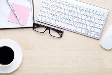 Wall Mural - Computer keyboard with notepad, glasses and cup of coffee on wooden table