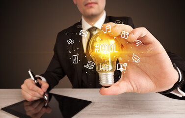 Businessman holding a light bulb, social media concept concept