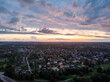 Late evening areal drone suburbs sunset view with small many private houses.