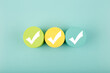 Three white checkmarks on colorful circles against bright aqua blue background