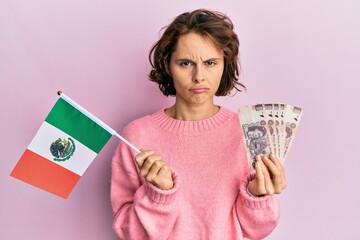 Sticker - Young brunette woman holding mexico flag and mexican pesos banknotes depressed and worry for distress, crying angry and afraid. sad expression.