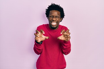 Poster - Young african american man wearing casual clothes smiling funny doing claw gesture as cat, aggressive and sexy expression