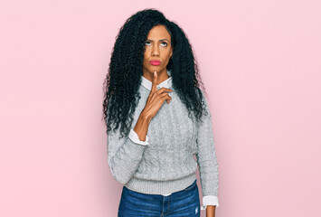 Wall Mural - Middle age african american woman wearing casual clothes thinking concentrated about doubt with finger on chin and looking up wondering