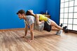 Man and woman couple training pectoral exercise at sport center