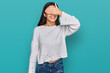 © Krakenimages.com - Young hispanic girl wearing casual clothes smiling and laughing with hand on face covering eyes for surprise. blind concept.