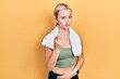 © Krakenimages.com - Young blonde girl wearing sportswear and towel showing middle finger, impolite and rude fuck off expression
