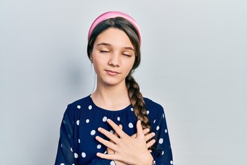 Sticker - Young brunette girl wearing elegant look smiling with hands on chest with closed eyes and grateful gesture on face. health concept.