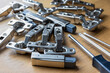 A pile of soft close cabinet door hinges and screwdrivers