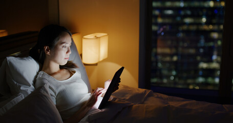 Canvas Print - Woman work on tablet computer on bed at night