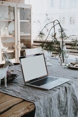 Wall Mural - Elegant aesthetic modern home office workspace. Laptop computer with blank mockup copy space screen. Bright cozy comfortable living room interior with Christmas decorations, linen table cloth