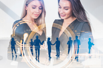 Wall Mural - Young attractive businesswomen wearing formal suits work together making deal