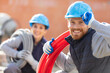 © auremar - female and male workers with electrical cable