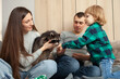 © Valeriia - pet raccoon, a child and an exotic animal indoor. Room, games with pet, gray raccoat. Animal in the family, care, love and friendship. joy, smiles and happiness