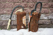 Two Old Abandoned  Rusty Fire Extinguisher Standing On Snow. Old, Abandoned Fire Equipment.  Fire Protection