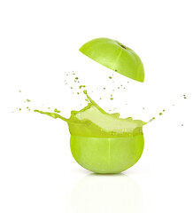 Gooseberry juice splashing from Indian gooseberry fruit (phyllanthus emblica, Amla) isolated on white background. 