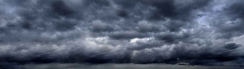 banner dramatic dark storm clouds black sky background. dark thunderstorm clouds rainny season. pano