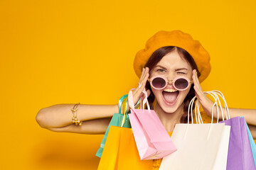 smiling woman in a yellow hat Shopaholic fashion style isolated background