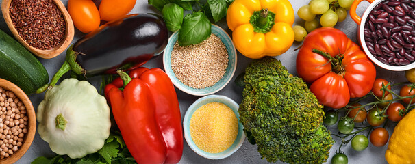 Wall Mural - Assortment of fresh fruits and organic multicolored rainbow vegetables on gray concrete background. Food cooking and healthy clean food background and mock up.