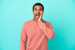 African American handsome man on isolated blue background with surprise and shocked facial expression
