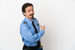 Young police man over isolated background white pointing back
