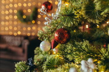 Close-up photo of Christmas decorations on the Christmas tree, multicolored red balls