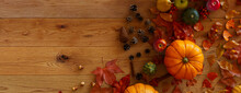 Top Down View Of Natural Wood Tabletop With Leaves, Pumpkins And Acorns.
