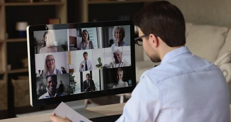 Wall Mural - virtual briefing. over shoulder view male worker meet with leader colleagues by pc screen discuss sa