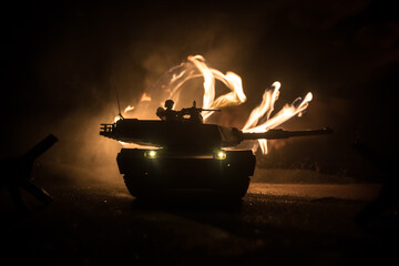 Wall Mural - War Concept. Armored vehicle silhouette fighting scene on war foggy sky background at night. American tank ready to fight.