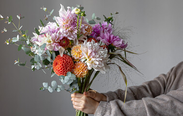 close-up of a bright festive bouquet with chrysanthemums in female hands.