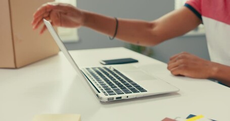 Wall Mural - Close-up of laptop standing on desk, phone next to it, box, dark-skinned man is working on computer, after finishing reports he turns off and closes computer, moves away from table